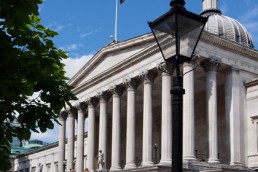 An image of UCL net-grecian portico with domed roof behind
