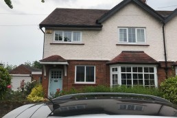 Two storey semi-detached 1930s property with upper facade in a cream pebbledash render