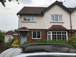 Two storey semi-detached 1930s property with upper facade in a cream pebbledash render